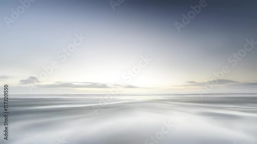 Monochromatic coastal landscape under a cloudy sky