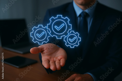 Businessman holding glowing gears with checkmarks representing successful process and workflow