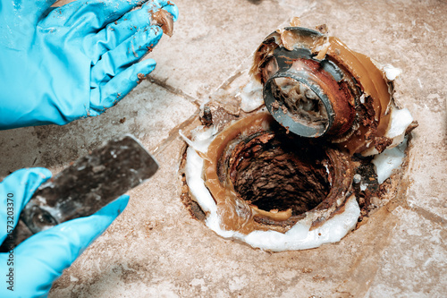Detailed image of the toilet base area with wax ring placement during plumbing maintenance with copy space.