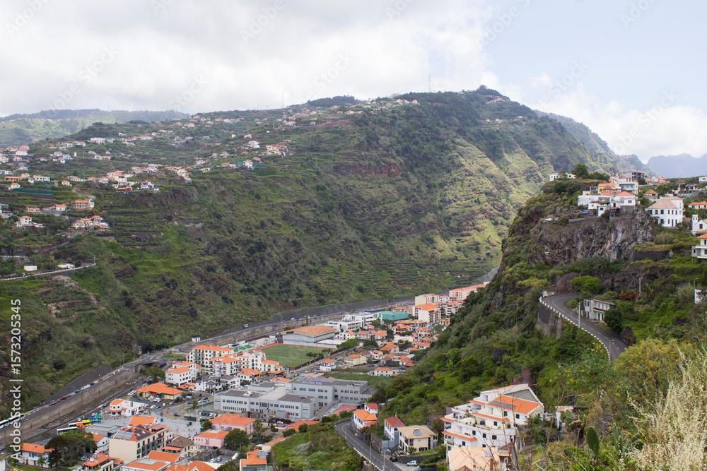Fototapeta premium Beautiful view of the city and mountains on a summer day. Top view. Ribeira Brava. Madeira. Portugal.