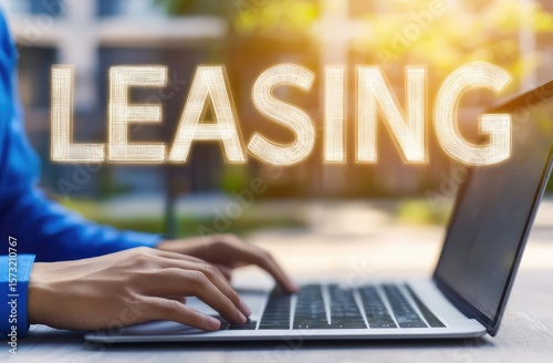 Person using laptop, focused on leasing