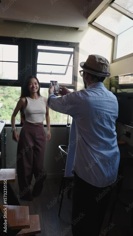 Happy couple taking photos and dancing in the kitchen a modern apartment Happy couple taking photos and dancing in the kitchen a modern apartment