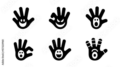 Set of six black silhouette hand icons with spooky halloween monster faces