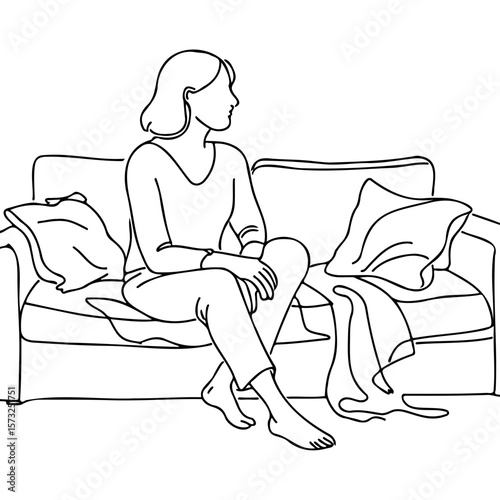 Woman sitting thoughtfully on a messy couch at home  