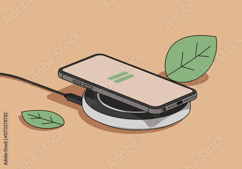 Smartphone charging on wireless pad with leaves on peach background  