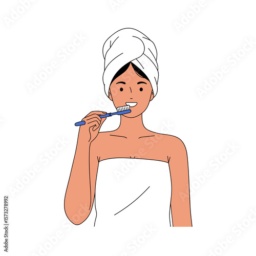 Young woman brushing teeth while wrapped in a towel in bathroom  