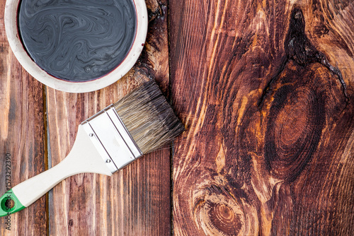 The procedure for protecting and coating wooden boards. The texture of wood treated with stain. Close-up of stain and brush.