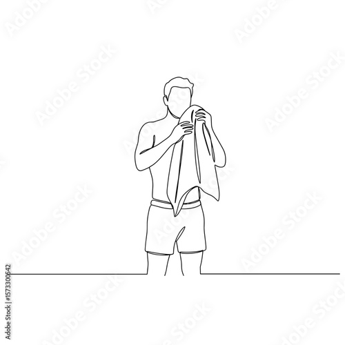 Man cooling off with towel while standing in minimalistic style  