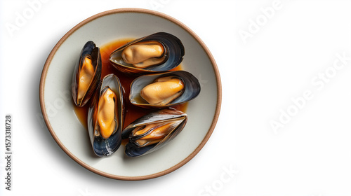 Freshly steamed mussels served in savory broth on a clean plate, ready to enjoy as a delicious meal option