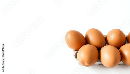 Fresh brown eggs on a white background, emphasizing simplicity and natural food.