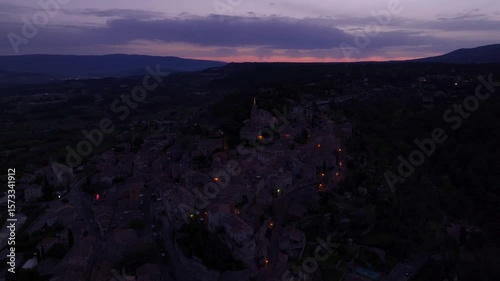 Aerial view of charming hilltop town Bonnieux under night sky in Provence