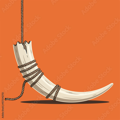 Ivory tusk tied with rope hanging, tusk of ivory is held aloft, a stark reminder of endangered species. Poignant image of ivory tusk tied as reminder of animal cruelty.