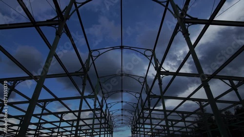 Timelapse video of dramatic clouds moving over a historic iron auction hall structure in Berlin, Germany.