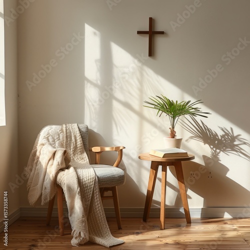 Home prayer corner with a chair, throw blanket, small wooden table with bible, cross on wall, indoor plant, tranquil Christian interior design
