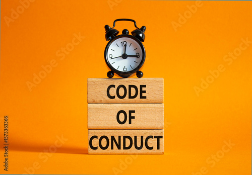 Code of conduct symbol. Wooden blocks with words Code of conduct with alarm clock. Beautiful orange background. Business and Code of conduct concept. Copy space.