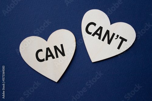 Can or Cant symbol. Concept word Can or Cant on wooden hearts. Beautiful deep blue background. Business and Can or Cant concept. Copy space