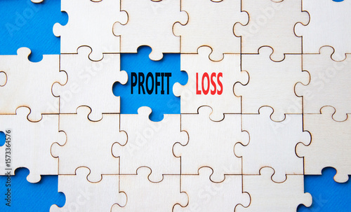 Profit or Loss symbol. Concept word Profit or Loss on wooden puzzle. Beautiful blue background. Business and Profit or Loss concept. Copy space