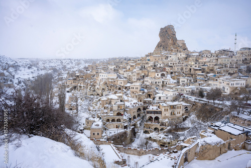 Snow-covered rock formation and a tree in Cappadocia. Breathtaking view of Valley in winter season, Uchisar Ortahisar Cappadocia National park