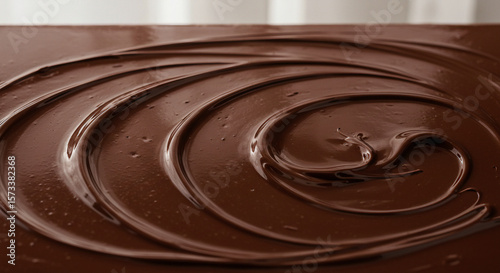 Close-up texture of rich, dark chocolate ganache swirls.
