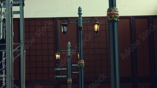 Vintage Street Lamps and Directional Signs in Indoor Setting