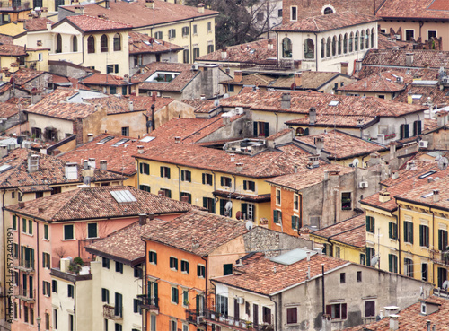 Fototapeta Naklejka Na Ścianę i Meble -  Verona. Italy. City center. Red roofs. Historic ancient city. Terracotta tiled rooftops. Narrow streets. Antic buildings. Medieval architecture. Compact urban layout. Old town. Traditional masonry.