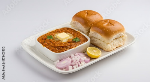 Pav bhaji indian street food mumbai cuisine traditional dish with buns butter lemon and onions on plate