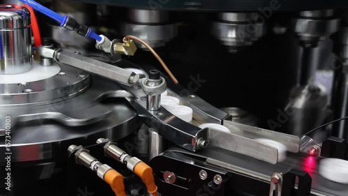 Plastics Cap making. Demo of Plastic caps moving through automated assembly machine in modern factory. Precision engineering and robotic in industrial plastic packaging and bottle cap manufacturing.