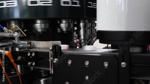 Plastics Cap making. Demo of Plastic caps moving through automated assembly machine in modern factory. Precision engineering and robotic in industrial plastic packaging and bottle cap manufacturing.