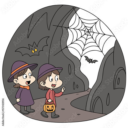 Two young children dressed as witches with pointy hats and capes walk through a spooky cave on halloween night carrying a jack o lantern candy bucket encountering bats and a large spider web