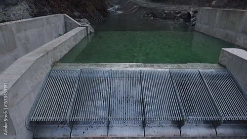 Drone over river water intake control structure. Ideal for environmental content, civil infrastructure, hydrology, and sustainability themes.