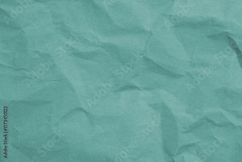 Crumpled teal paper with wrinkled and textured background