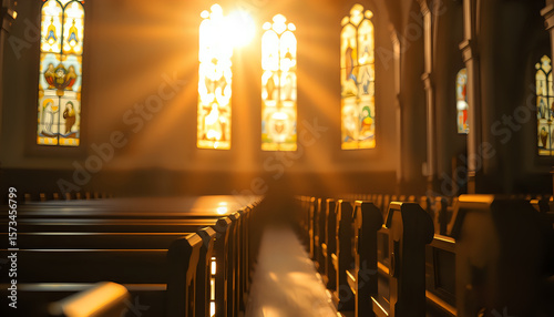 Peaceful church interior with warm sunlight through stained glass, highlighting empty wooden pews.
