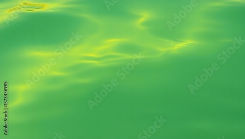 Emerald green liquid reflects soft light, creating a soothing and mesmerizing aquatic texture for backgrounds, wallpapers, or abstract designs emphasizing serenity and vibrant hues.
