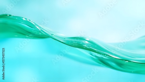Clean turquoise water surface creates a fluid wave with droplets glistening in the light, showcasing fresh aqua colors and serenity in a minimalist composition.