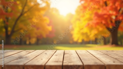 Empty rustic wooden table with blurred background of vibrant autumn forest