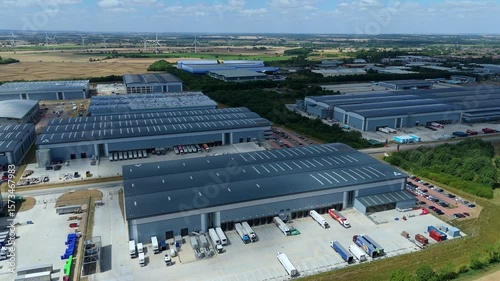 Aerial drone perspective distribution centers and industrial warehouses and data centers centres Quantum computing business hub super market distributor near Biggleswade England UK