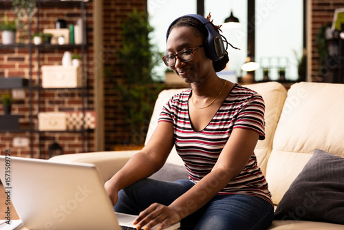 Slika na platnu Young female adult with smile on face, listening to music and happily exploring travel destinations for vacation