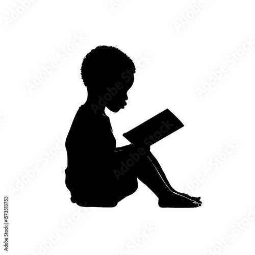 Silhouette of a child seated reading a book with focus and concentration in a quiet moment of learning