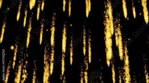 Shimmering gold dust falling against a dark background  