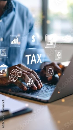 Tax Time Person types on a laptop surrounded by transparent icons related to money and finance