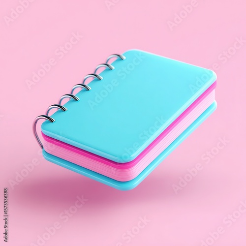 A colorful spiral notebook with a pink and blue design, floating against a soft pink background, Ideal for representing creativity, organization, or study themes in marketing or educational materials