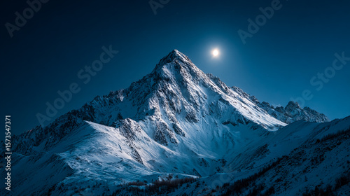 Majestic peak glows under the moonlight. Snowy mountains at night. For travel, nature, or adventure themes. Perfect for web use, marketing, or editorial.