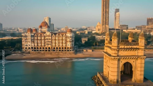 Aerial View of the Gateway of India Monument in Mumbai India with Buildings and Water in Golden Sunlight