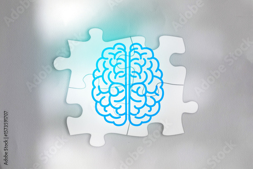 Conceptual illustration of human brain symbol divided into left and right hemispheres on connected jigsaw puzzle pieces. Represents cognitive function, problem solving, mental health