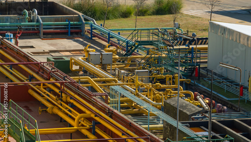 Complex network of colorful pipes, valves, and industrial infrastructure at a processing or water treatment plant