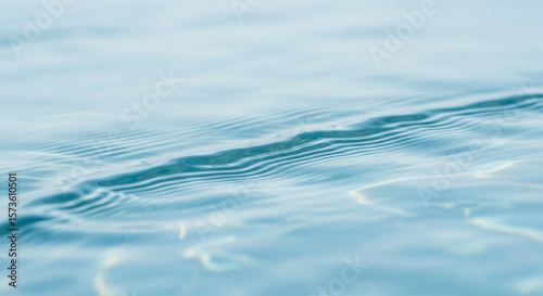 Close-up of clear, rippling water surface, showing subtle light reflections and gentle movement.