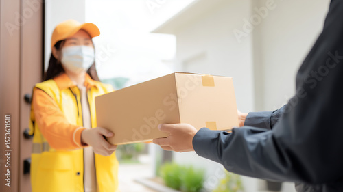 Wallpaper Mural A Seamless Parcel Delivery Exchange concept captured as two hands transfer a cardboard box outside a home.
 Torontodigital.ca