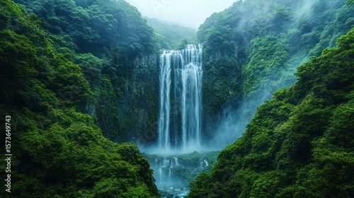 Lush mountain valley with a cascading waterfall.