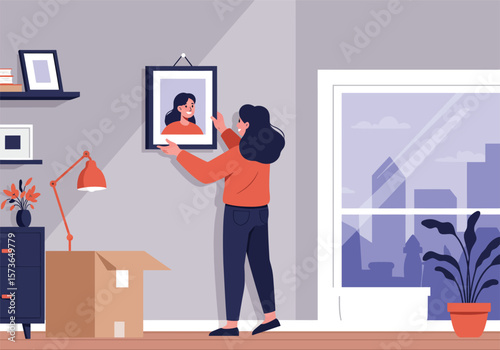 Woman Hanging Picture Frame in a Stylish Apartment.