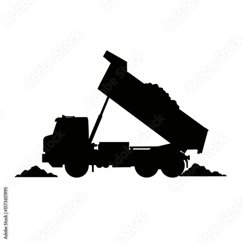 Silhouette of a dump truck unloading its heavy cargo onto the ground.